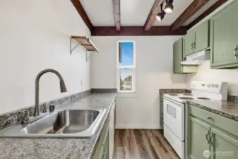 Kitchen with new cabinets, countertops, and sink. All appliances included.