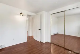 3rd Bedroom with same mirrored closet and laminate flooring.