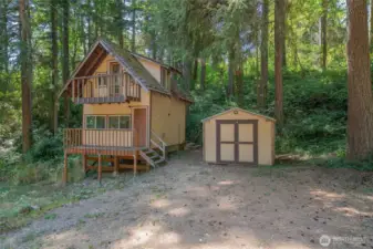 Front of cabin with storage shed.