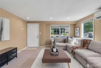 Enter the living room filled with natural light and ample space for entertaining
