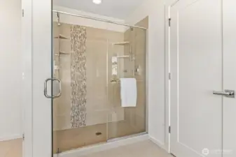 Walk-in shower in primary suite has two shower heads