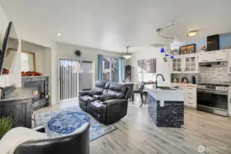 Open concept living area has bright natural light with updated details as stack stone gas fireplace surround, Dining light/fan(hidden) & 5 burner gas stove/oven