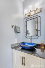 1/2 bath on main floor had new vanity, granite countertop and custom glass vessel sink