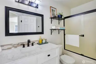 Updated vanity, backsplash, flooring, lighting and full tub/shower combo.