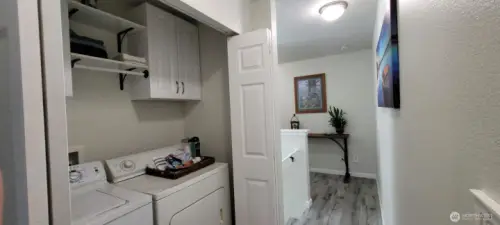 Laundry area, washer and dryer convey, cabinets & additional shelving
