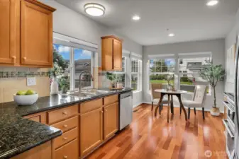 Kitchen with stainless steel appliances, eating space, Brazilian hardwoods.