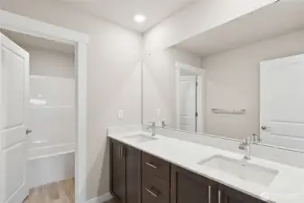 Guest bath with tub shower combo and quartz countertops with dual sinks!