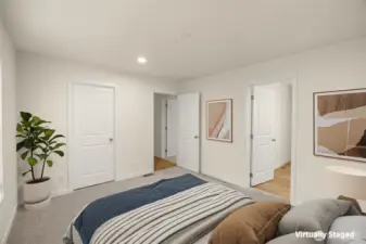 Virtually staged primary suite with attached bath to the right
