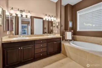 Your Primary Ensuite is comfortably equipped with a soaking tub, dual sinks and lighting, fabulous tile flooring and surround with inlay, and marble counter tops.