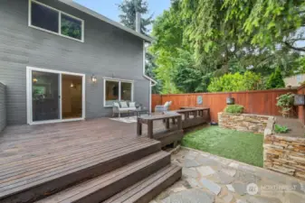The sliding glass door provides seamless access from the living room to this inviting outdoor deck, perfect for entertaining. The gate to the left conveniently leads to a spacious storage room, offering extra utility and organization.