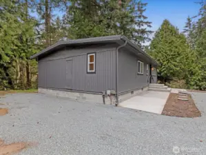 Parking area and paved walk to the front door.