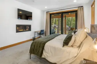 Primary Bedroom with slider to deck, and fireplace.