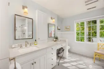 The spacious primary bathroom is light and bright.