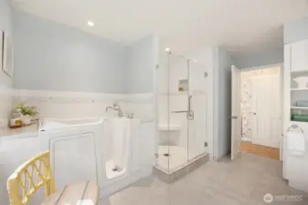 Primary bath features easy access bath, gorgeous tile shower, tile floors.