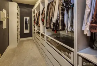 Expansive walk-in closet offers custom built-in shelving, drawers, and hanging space—perfectly designed for effortless organization and everyday convenience.