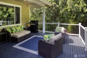 Relax and entertain year-round on the spacious covered deck, complete with a grill area; ultimate privacy and tranquility.