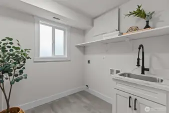 This light, bright utility room even features a laundry-chute from the bedroom wing upstairs!