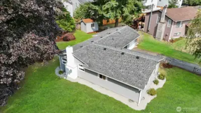 Mature trees bring shade to the private, fully fenced yard. Green grass has been digitally altered in photo.