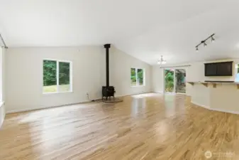 Large sunny great room with propane fireplace for cozy winter days.
