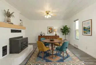 Large dining area with wood stove. Could also be used as additional living room space. DIGITALLY STAGED