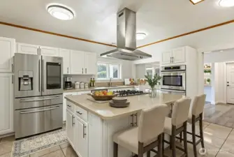 This is a HUGE kitchen with stainless appliances and solid surface countertops. SO much storage! Digitally staged