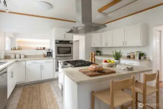 Spacious kitchen (digitally staged) Double ovens and gas stovetop are very handy features!