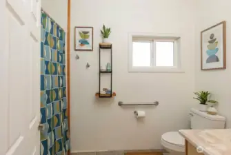 Full bath on main level, digitally staged.