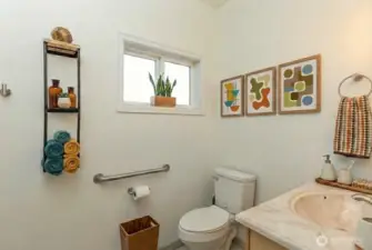 Full bath on main level, digitally staged.