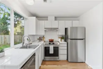 Tile counters and stainless steel appliances are ready for your meal preparation.