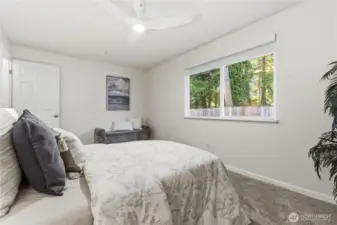 Large window in this Primary bedroom views the fenced rear yard.