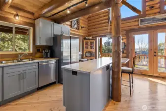 What chef wouldn't love crafting fine meals here with so much natural sunlight and beautiful cabinets and quarts counter tops.