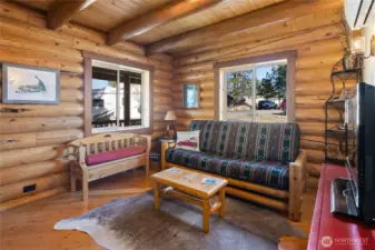 View of main floor bedroom. Currently being used as a TV room or office. Look at all the character with these beautifully hand milled logs.