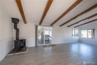 Gas fireplace in the living room with sliders to the driveway