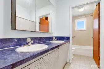Full bathroom with double sinks & shower/ tub