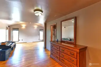 Large primary bedroom with en-suite and hardwood flooring