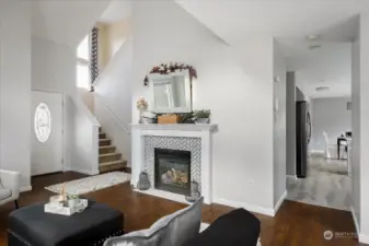 Coming back downstairs - it's so lovely to enjoy the warm and inviting fireplace...Now let's go tour the kitchen! Behind the mirror previous owner had a large TV!