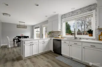 The bright and airy kitchen is a welcoming space, perfect for preparing meals and inspiring creativity with its open layout and natural light.