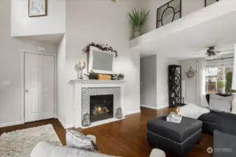 Home has so many artistic angles and all are enhanced with the warm and inviting fireplace. To the left of the fireplace is the coat closet and out of picture, stairway to upstairs bedrooms and laundry room.