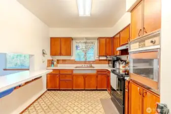 From the kitchen window, you can take in a peaceful view of the surrounding trees, a reminder of the privacy this property offers. The kitchen itself is spacious and ready for use as it is, while also providing the opportunity for updates if you’d like to put your own stamp on the space!