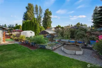 Garden beds, greenhouse, chicken coop, sandbox for the littles!