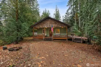 Your adorable cabin in the woods! I love the private setting, huge wrap-around deck and all the parking.