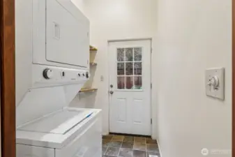 Utility room and back entrance with include stacking washer and dryer.