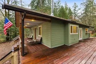 Side outdoor pic showing huge wraparound deck that covers your front, side & back, amazing place to RELAX and listen to all the birds.