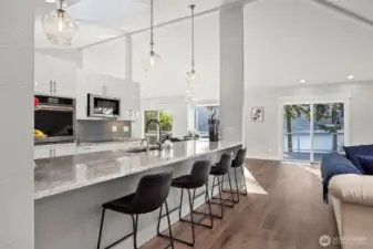 Opening up to a spacious west facing deck with panoramic lake views.