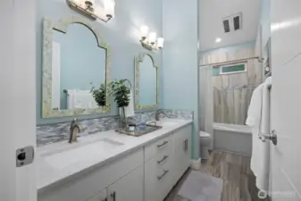 Full guest bath with dual vanity on the main level.