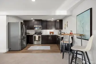 Confortable kitchen with eating space and new stainless fridge.