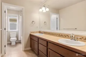 Upstairs full bathroom with dual sinks