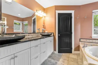 Dual sinks and a door on the commode for extra privacy.