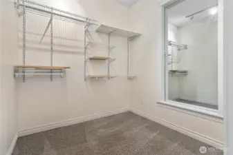 Walk-in closet is more like an additional room. There are water lines stubbed into the wall on the right. You could put a washer/dryer in here.