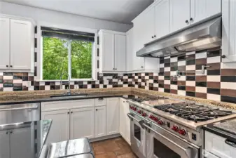 The kitchen is a chef's dream, complete with Wolf 6-burner range, grill, and double-oven. Also has a built-in pot filler.